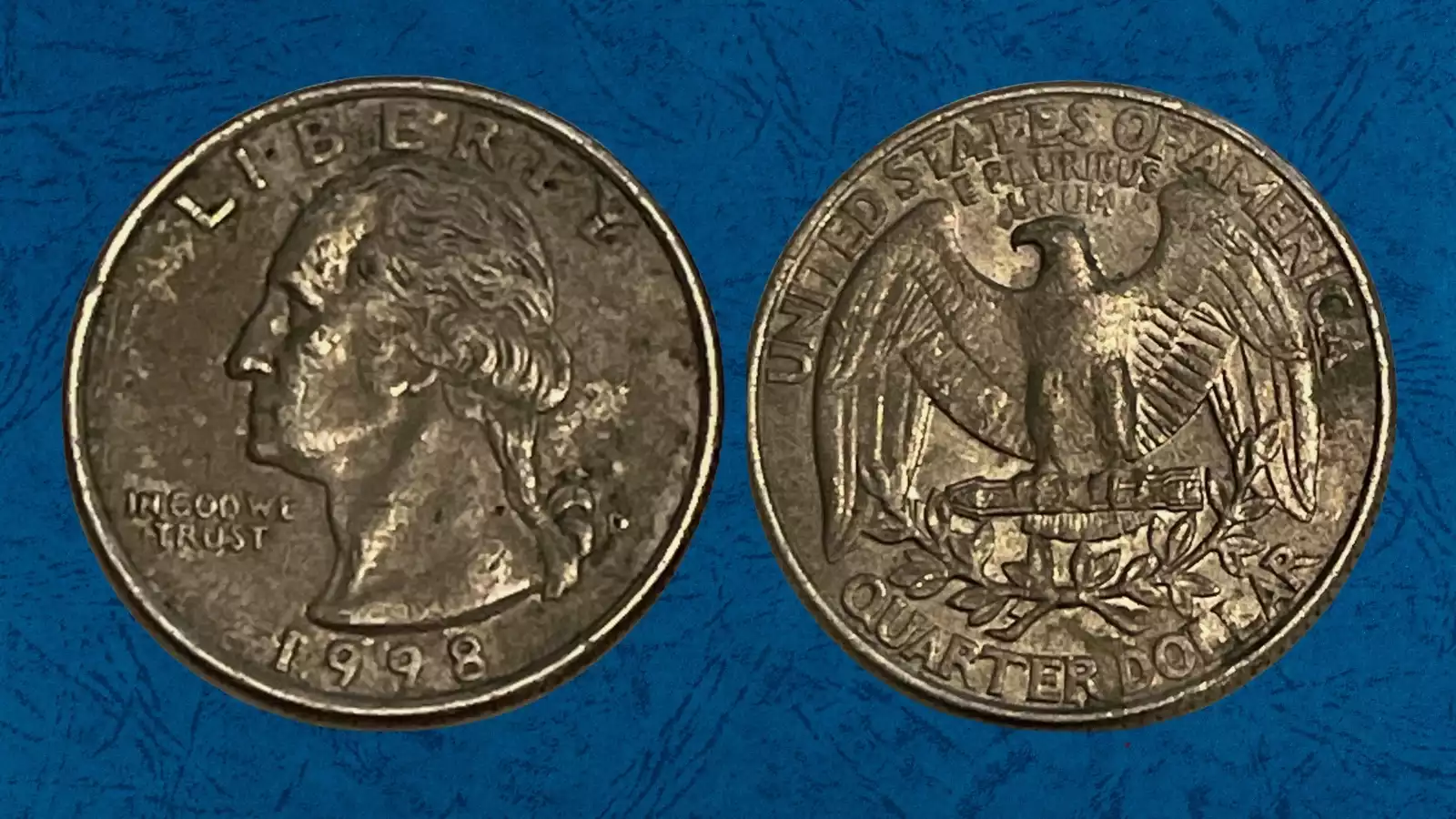 1998 quarter missing clad layer error showing normal copper-nickel obverse alongside exposed copper-brown reverse core